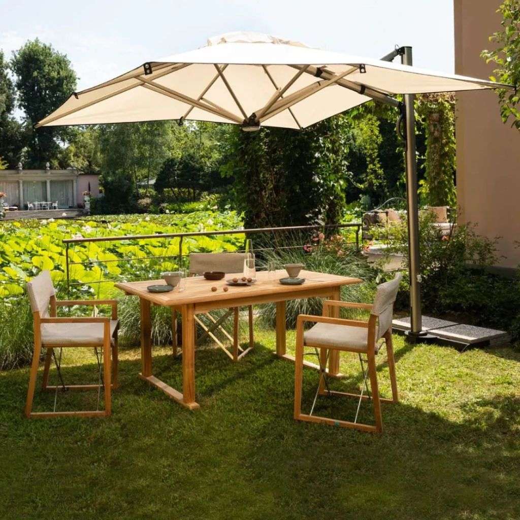 Stylish outdoor dining table and chairs with umbrella by Unopiu.