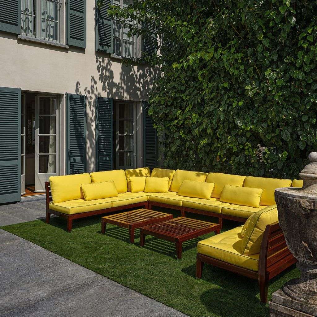 Yellow outdoor sectional seating with wooden frames by Unopiu.
