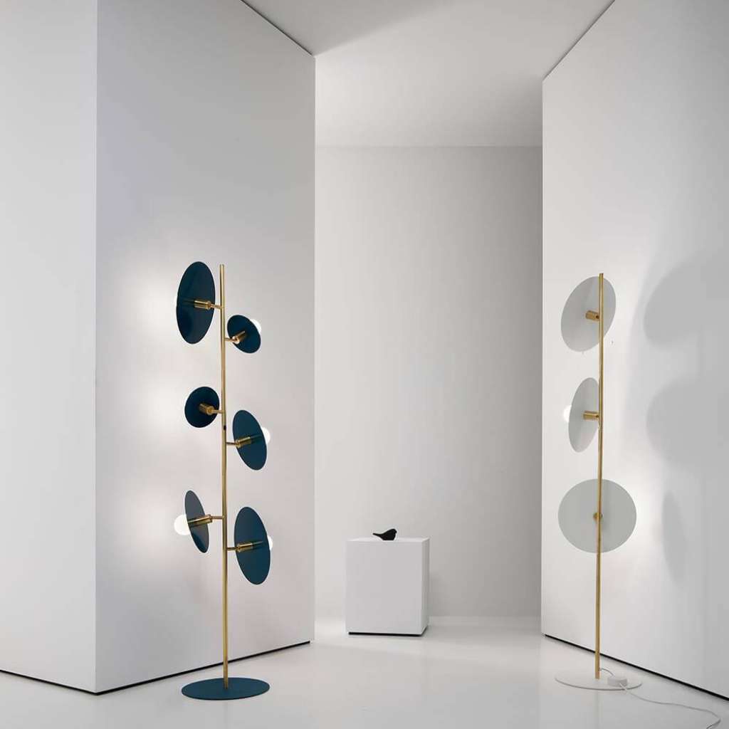 Vesoi disc floor lamps in teal and white with brass stems.