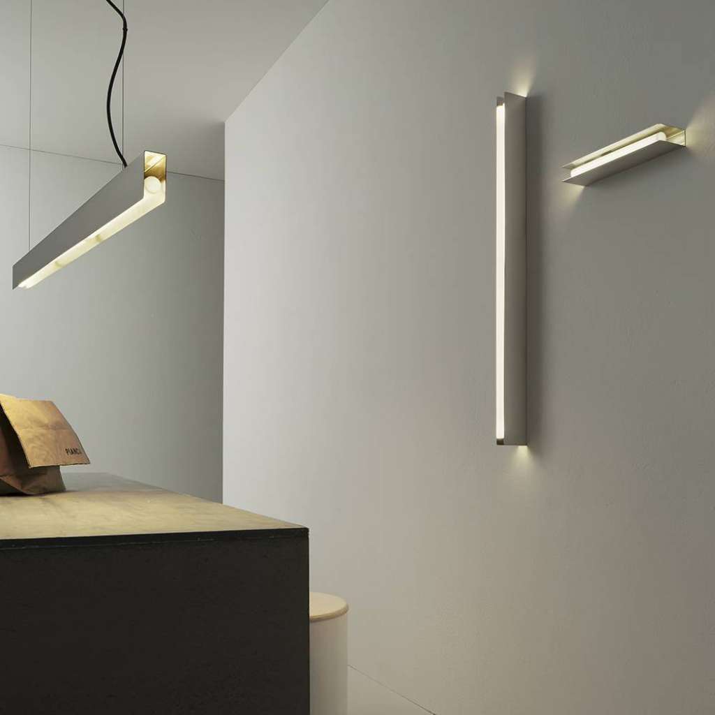 Vesoi slim modern wall and ceiling light fixtures illuminating a minimalist space.
