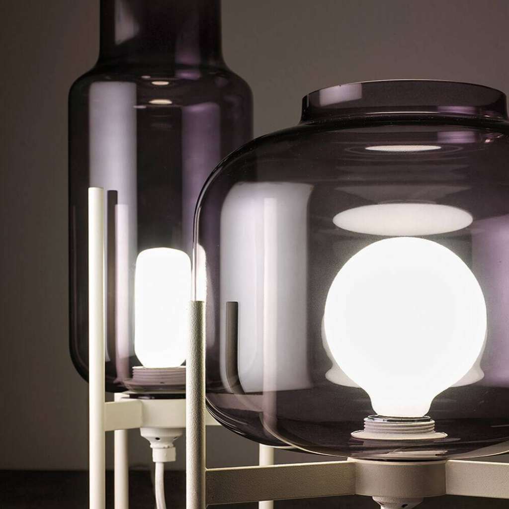 Vesoi smoked glass table lamps with exposed bulbs.