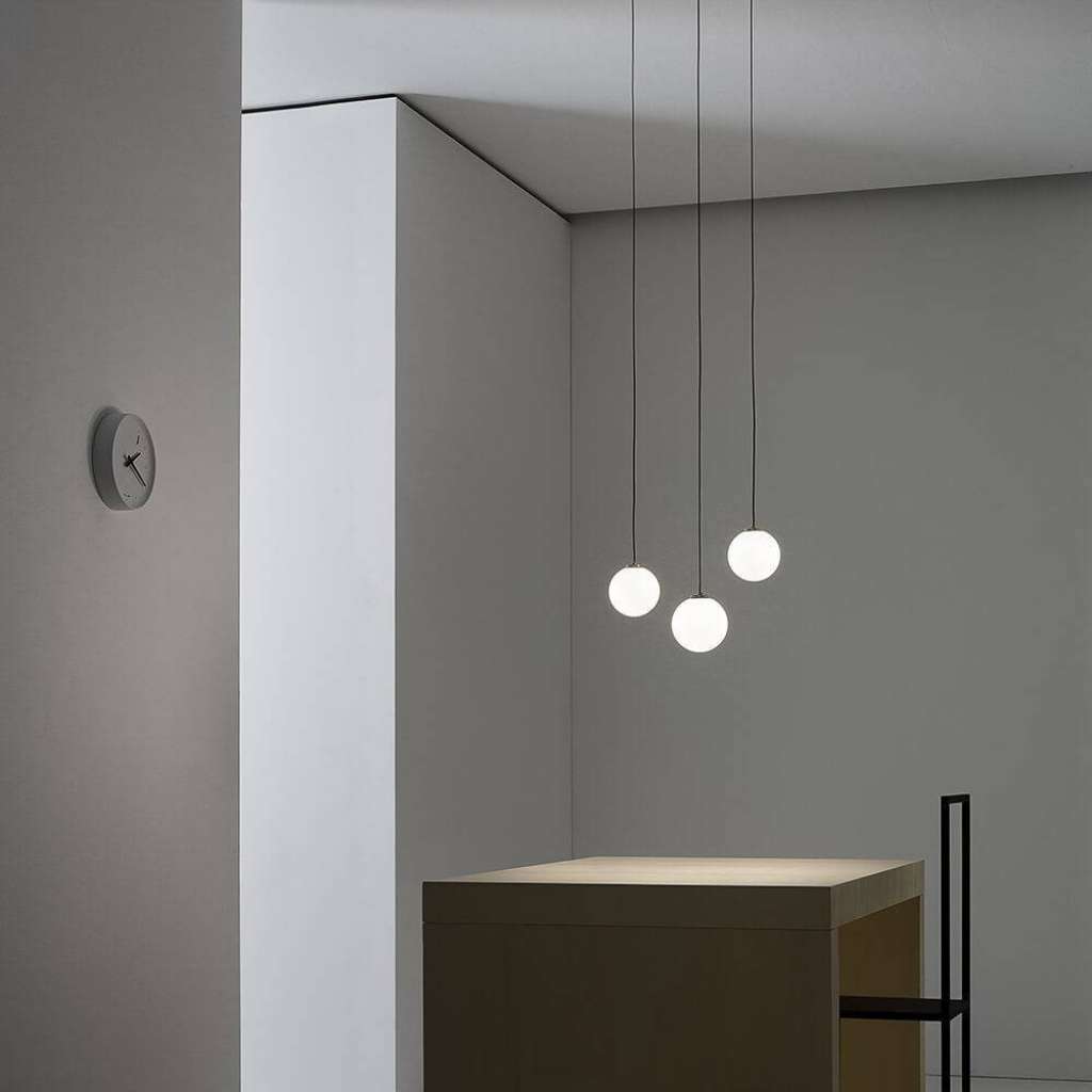 Vesoi triple pendant globes above a minimalist table setting.