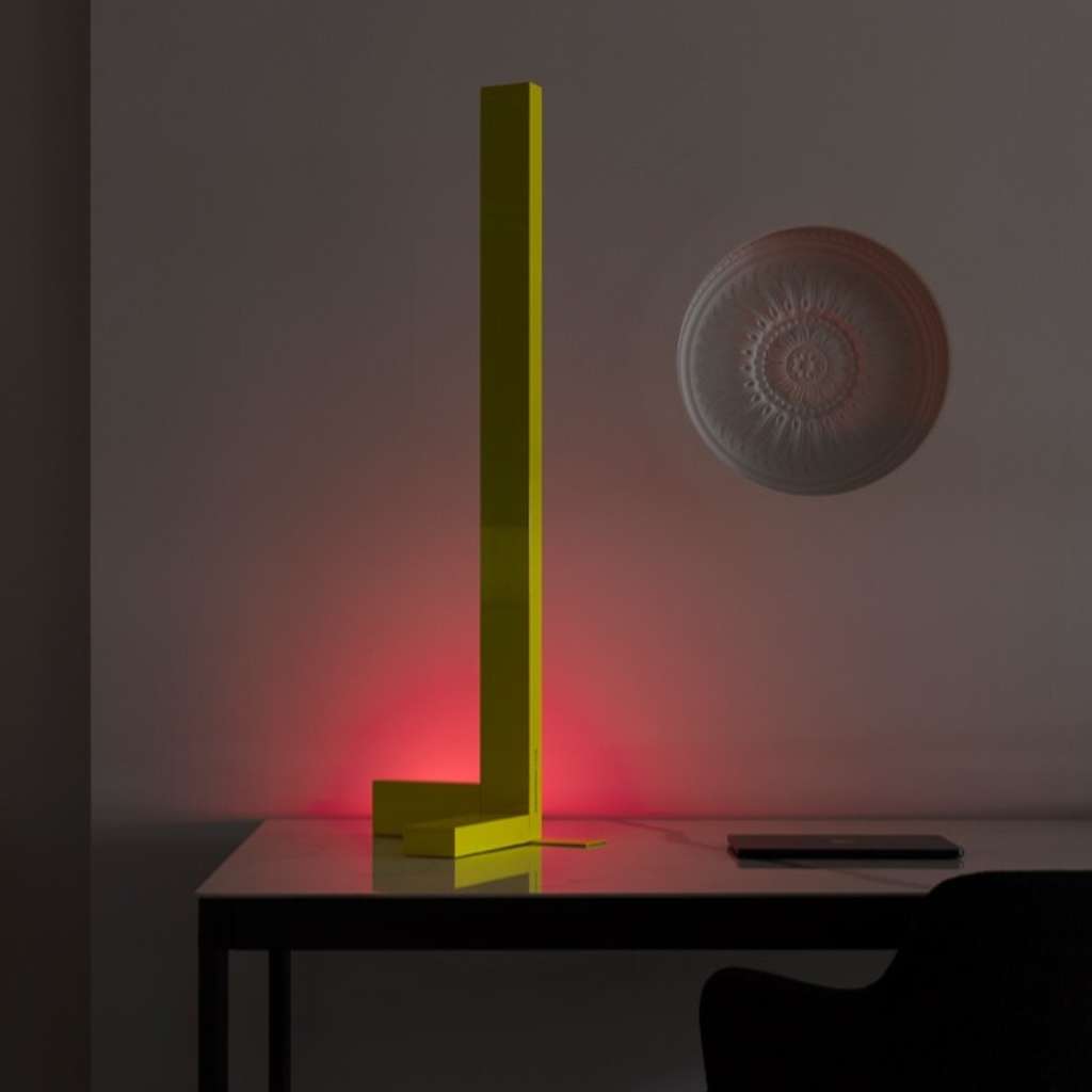 Vesoi neon yellow L-shaped desk lamp with pink backlight.