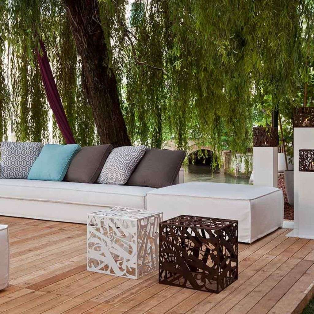 Villevenete contemporary outdoor seating area with white cushions and intricate metal side tables.