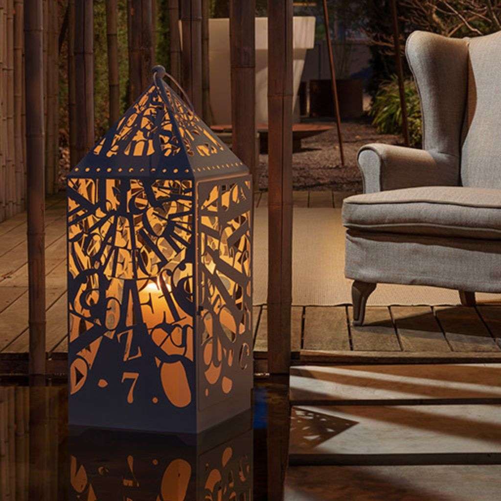 Villevenete outdoor lamp with intricate cut-out design illuminating the surroundings.