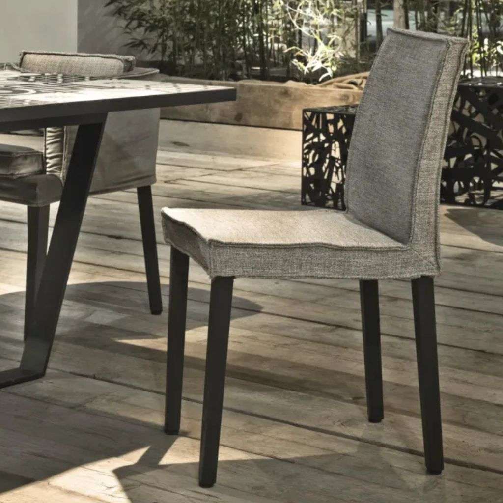 Villevenete simple and elegant grey dining chair paired with a stylish table.