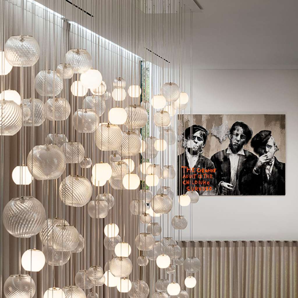 Vistosi glass chandelier with artistic light patterns, elevating any interior with elegance.
