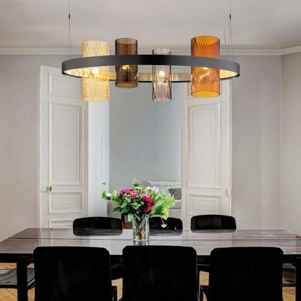 Vistosi sculptural chandelier above a dining area, blending art and functionality in lighting design.