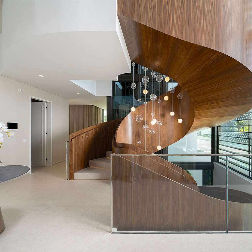 Vistosi staircase design featuring suspended glass lighting fixtures for a sleek and sophisticated look.