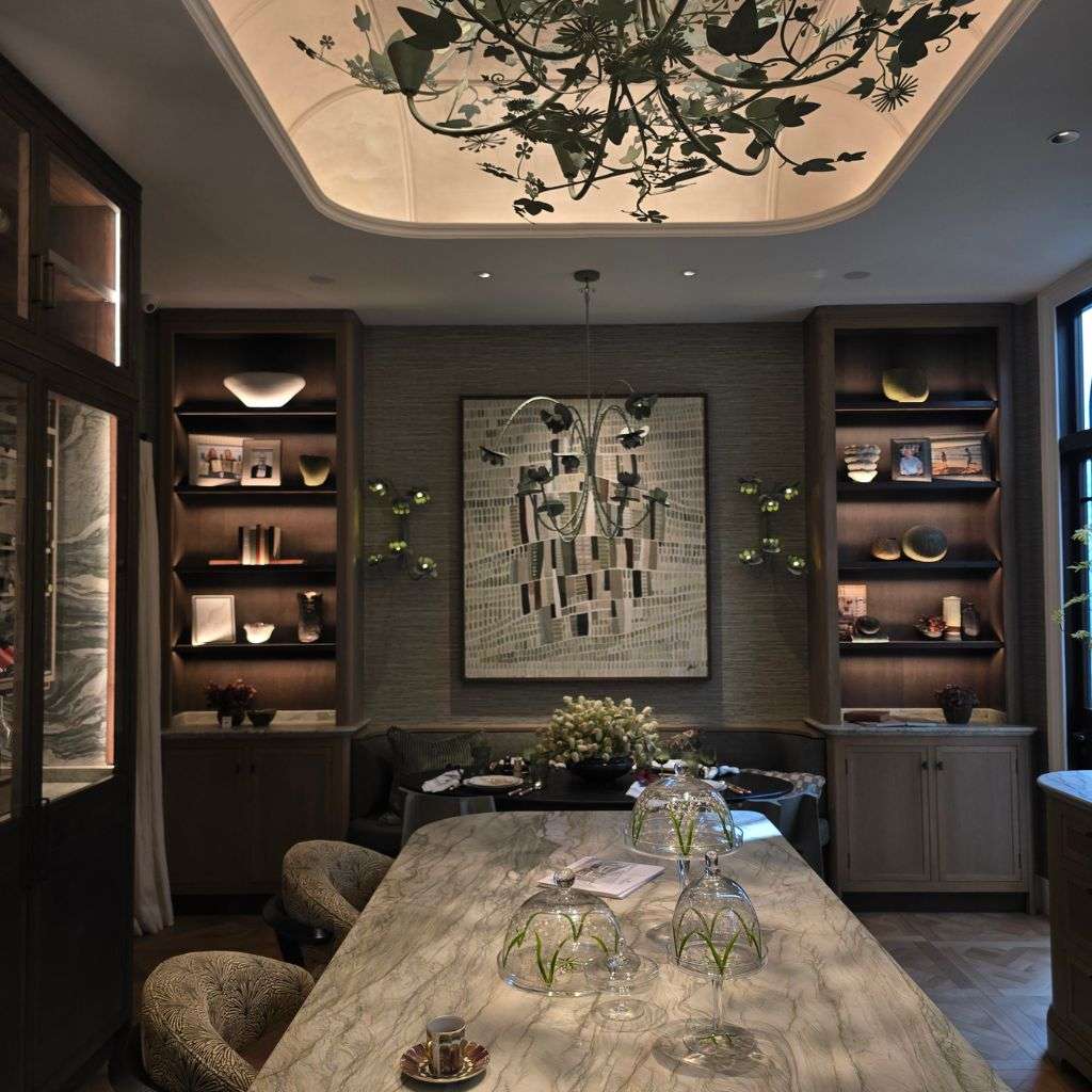 Traditional library with bespoke bookshelf, accent lighting and floral wallpaper