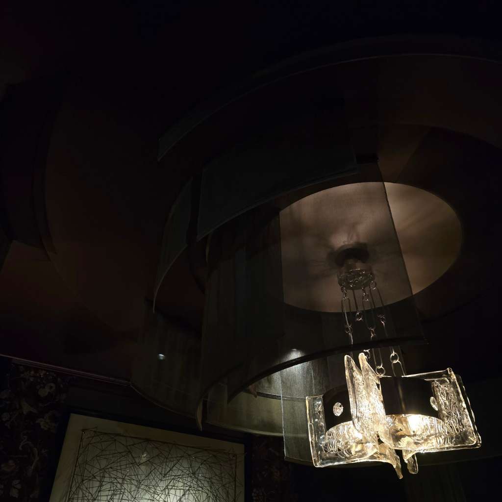 Luxury ceiling design featuring sculptural glass pendant lighting and fabric panels