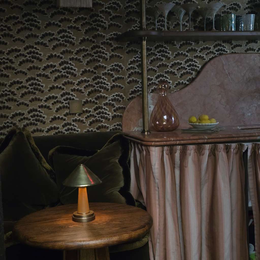 Deep colour interiors with patterned wallpaper, marble bar, rich fabrics and ambient designer lighting