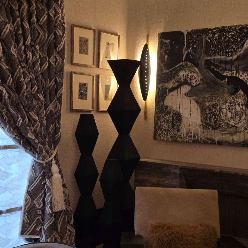 Luxury bedroom corner with geometric textiles, sculptural décor and feature lighting