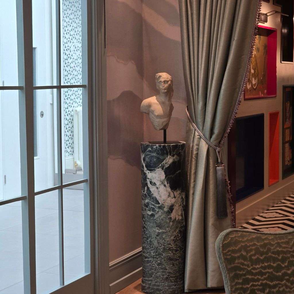 Marble pedestal with classical sculpture in luxury contemporary interior