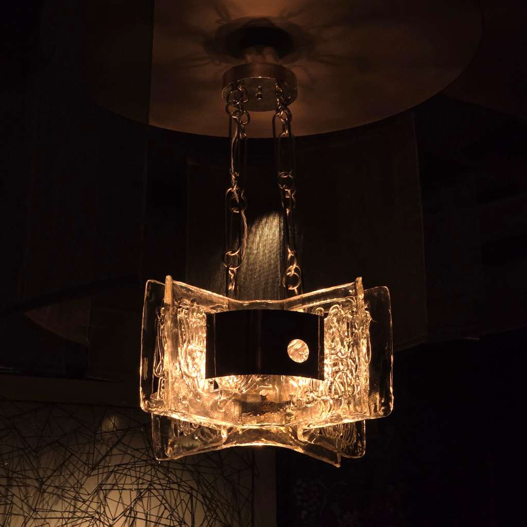 Sculptural glass statement pendant lighting in a luxury interior setting