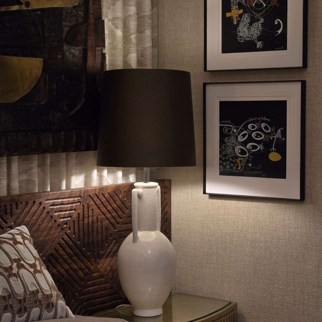 Designer bedside styling with ceramic table lamp and artwork at WOW!house 2026