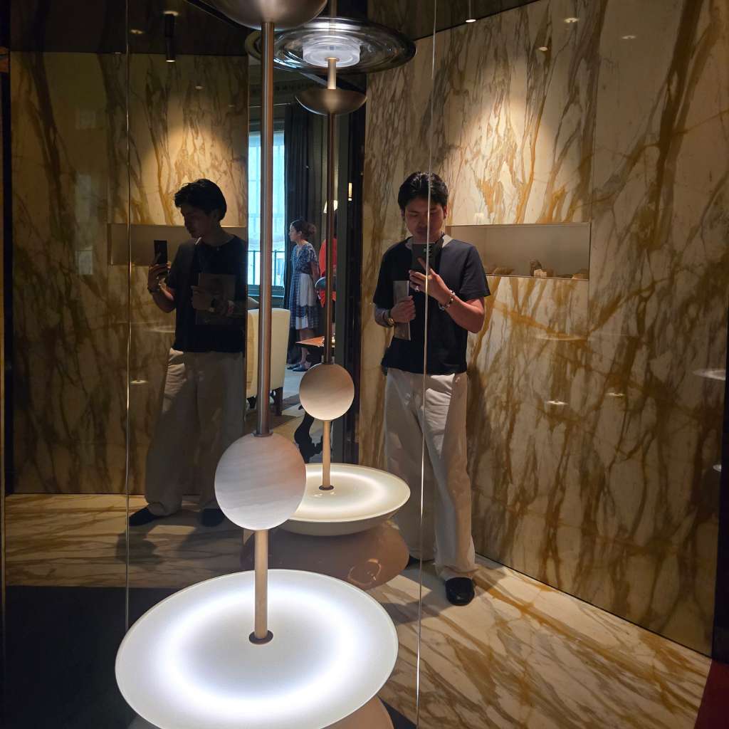 Interior designer viewing sculptural lighting at WOW!house 2026 Shepel Library