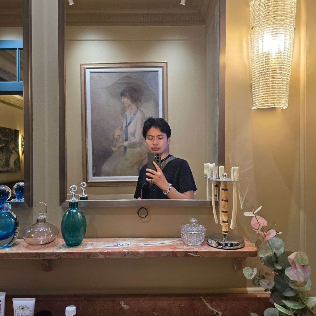 Interior designer photographing luxury bathroom with marble vanity and mirror