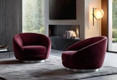 Plush burgundy armchairs with a minimalist design in a luxurious living room.