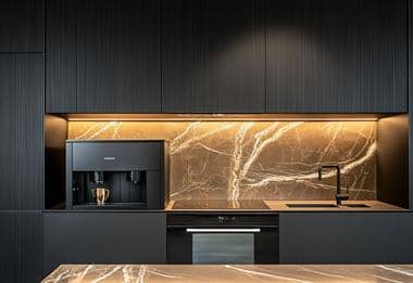 Built-in black coffee machine with marble splashback and matching cabinetry