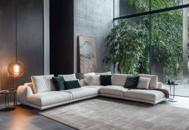 Minimalist modular corner sofa with green pillows and modern design