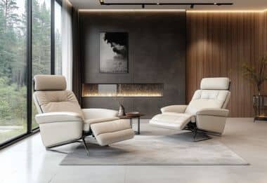 Relaxing recliners in serene living room with large windows and fireplace