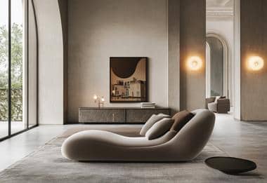 Contemporary curved beige sofa in luxurious living room with natural light and minimalistic decor.