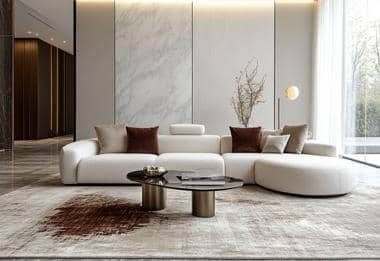 White sofa and dark table on a neutral rug in a modern living room.