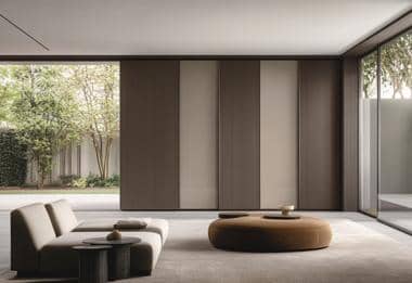 Minimalist living room with taupe built-in wardrobes and low grey modular sofa