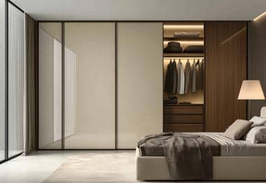 Modern sliding wardrobe with cream gloss doors in a minimal neutral bedroom.