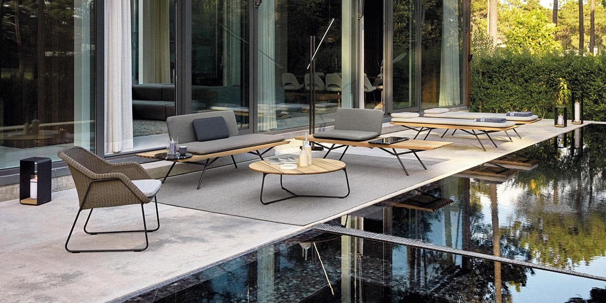 FCI London green wicker furniture and coffee table; relaxed, modern outdoor entertaining.