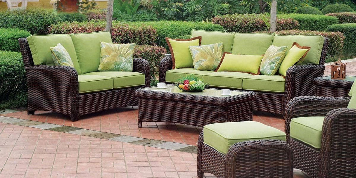 FCI London green wicker outdoor set with coffee table; chic, comfortable garden seating.