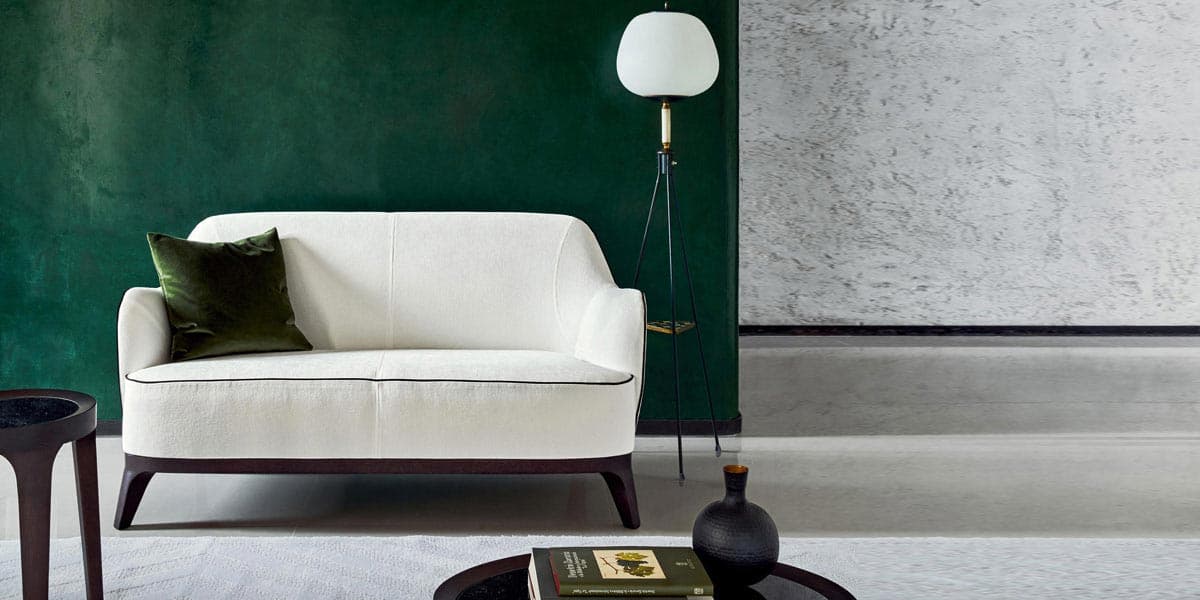 FCI London Flexform low-profile sofa with slim arms and plush feather cushions.