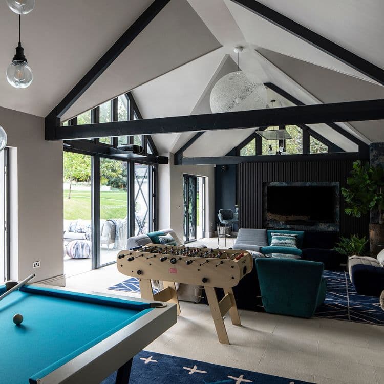 Another view of the Coulins project game room with window-adjacent sofa