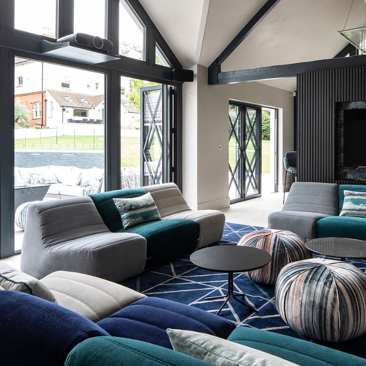 Open-plan game room with modular sofa positioned near window