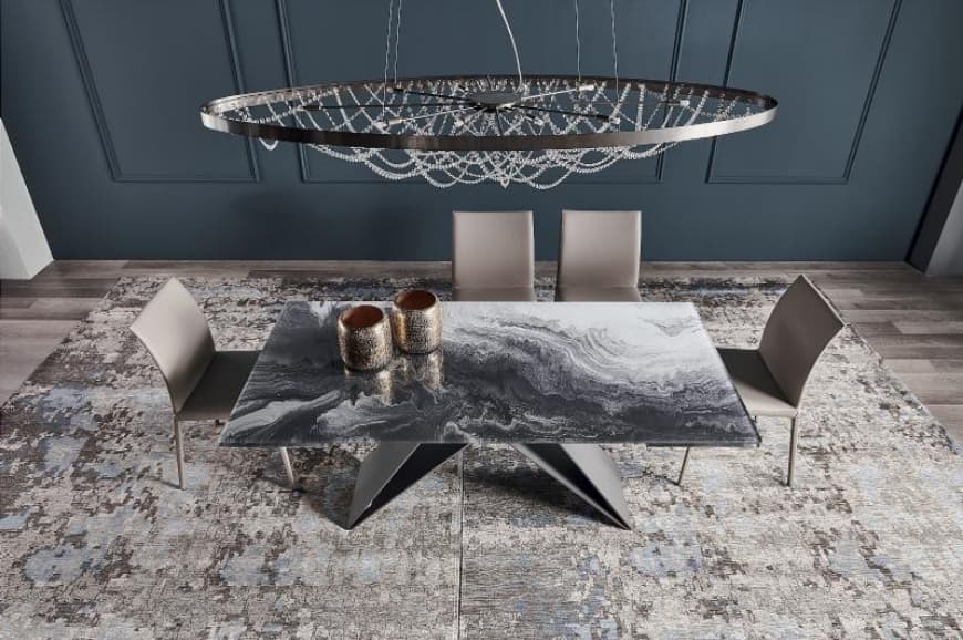 FCI London dining table under statement chandelier with polished tableware.