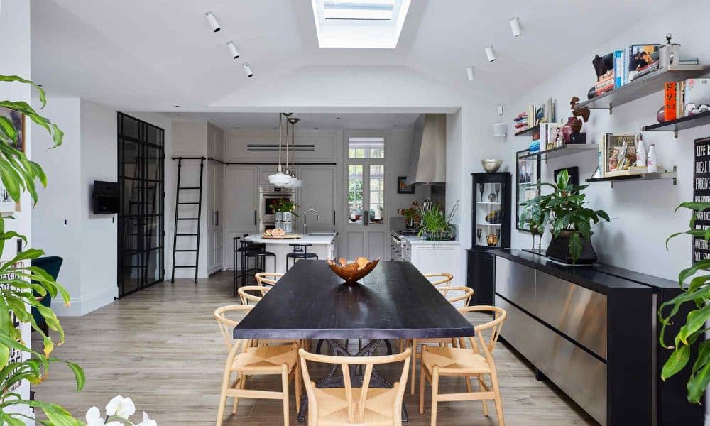 FCI London luxury dining table with candles, layered plates and crystal glassware.