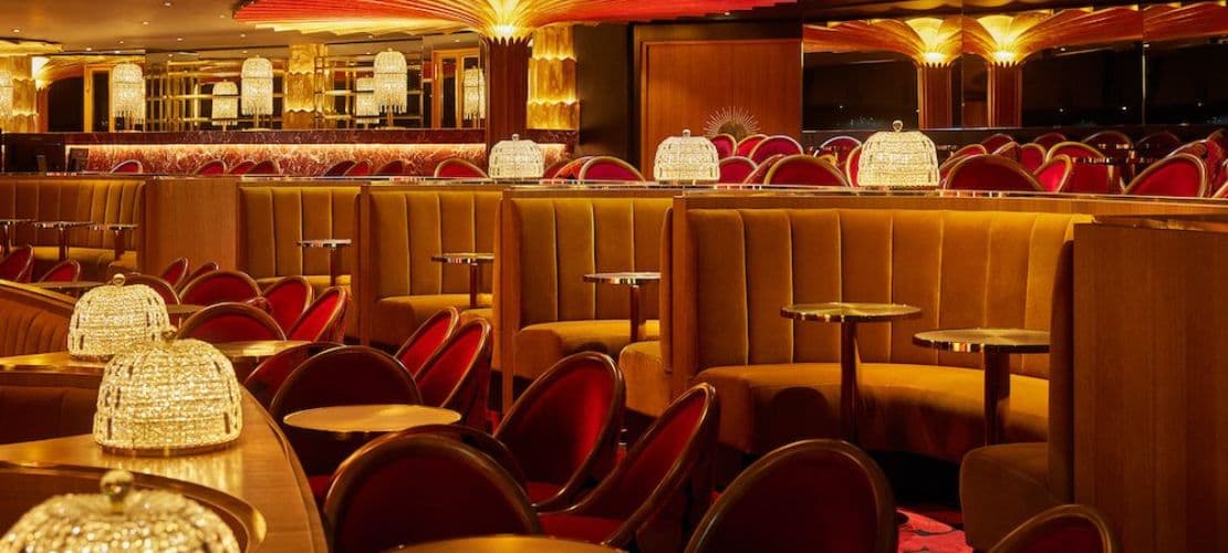 La Fibule lounge with elegant crystal lighting and plush velvet seating.