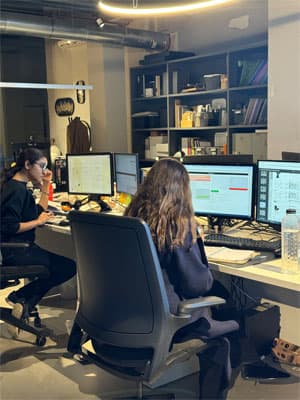 FCI team member in front of the work setup fci london