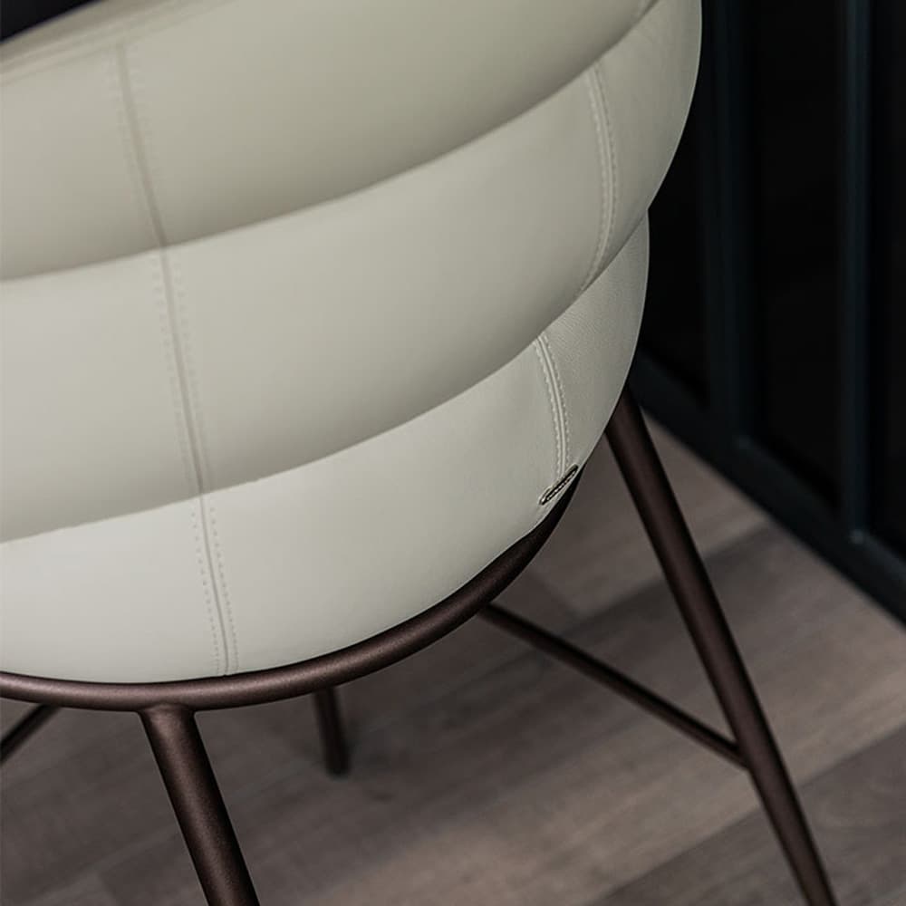 Camilla bar stool with a close-up of its upholstered seat and elegant backrest details