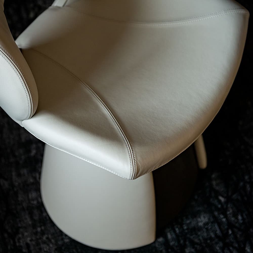 Close-up view of Dafne armchair's upholstered fabric and titanium frame from FCI London