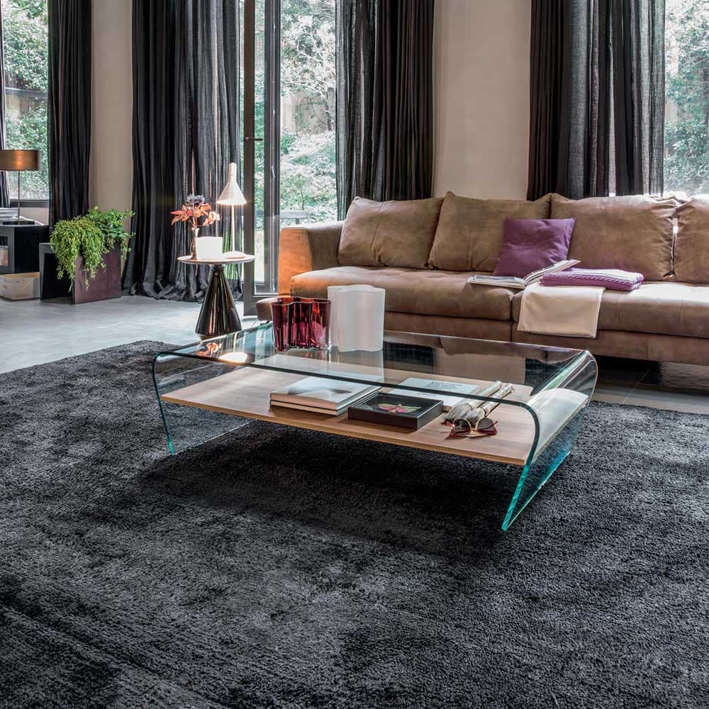 Amaranto Coffee Table by Tonin Casa with curved glass form and warm wooden shelf