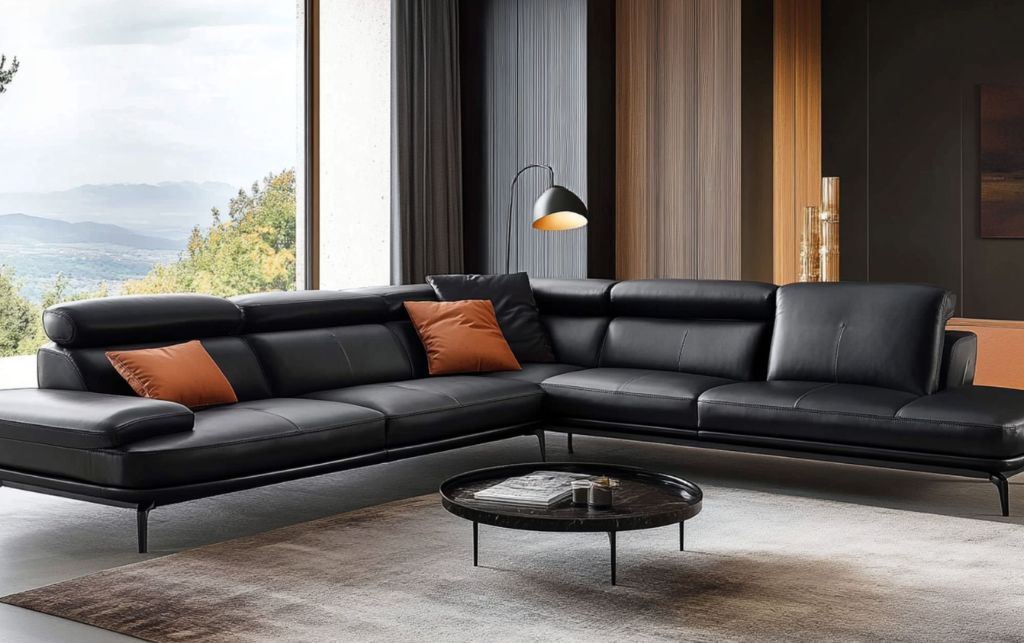 Contemporary black leather sofa with plush cushions and artistic wall décor.