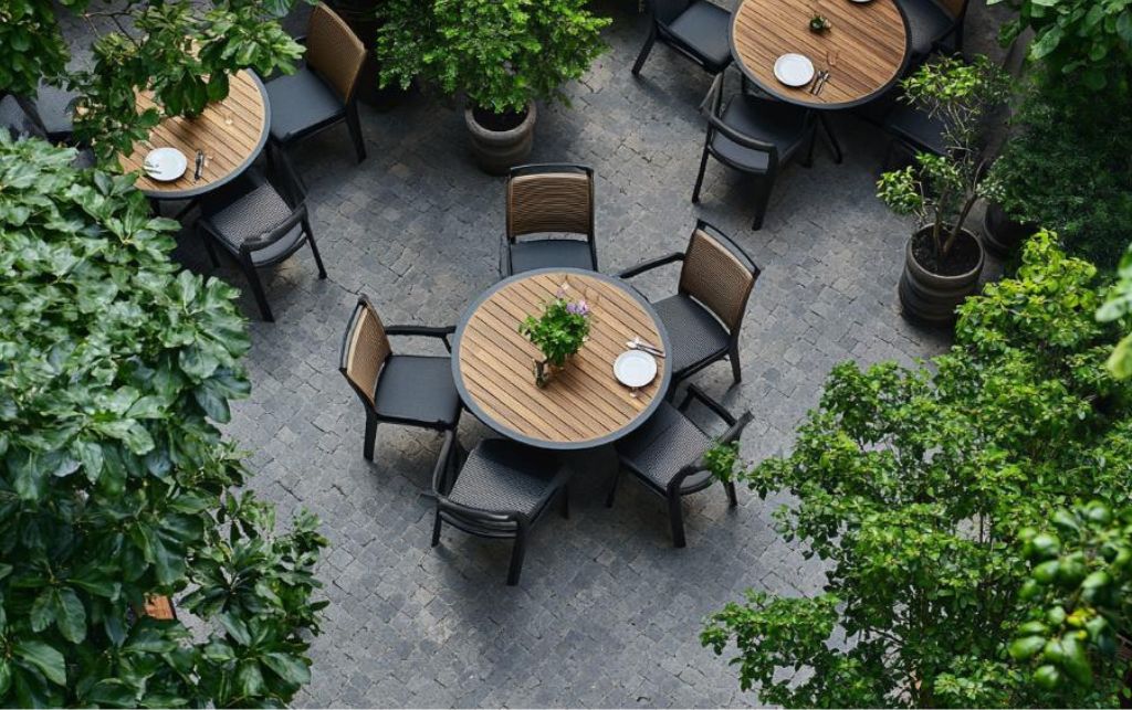Outdoor dining table with greenery