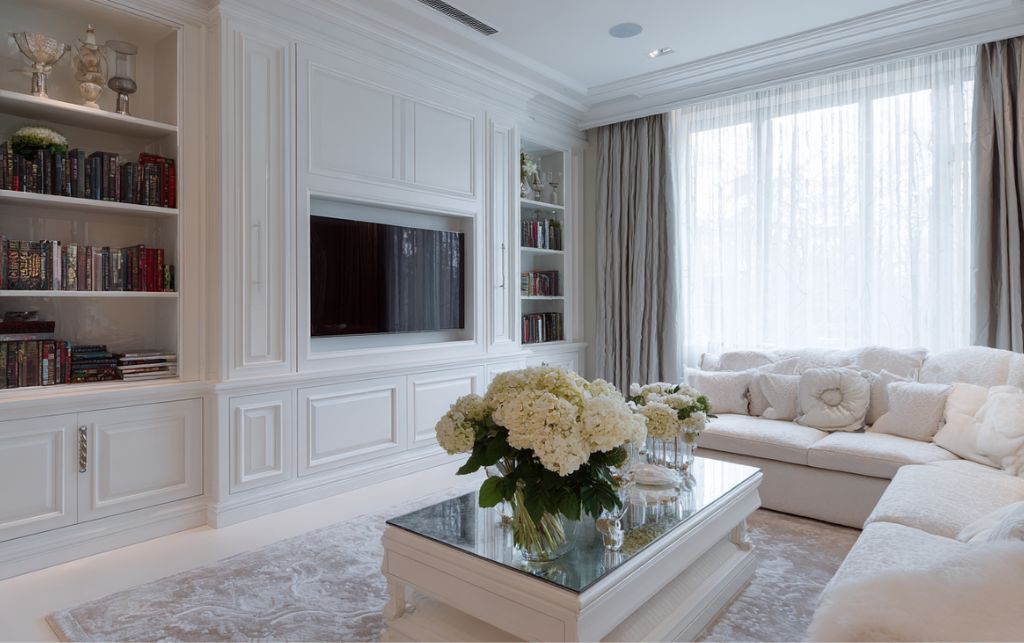 Built-in white TV cabinet integrated seamlessly with wall panelling and architectural elements
