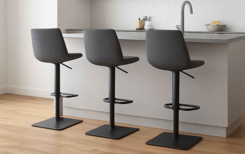Variety of designer grey bar stools arranged around contemporary kitchen island
