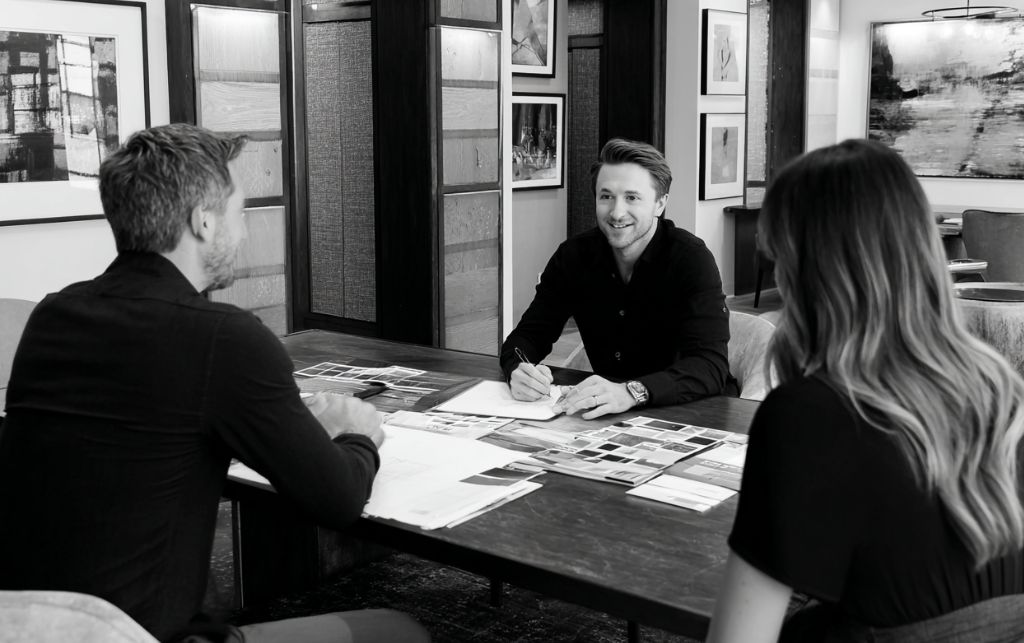 Interior designer meeting with client discussing project requirements