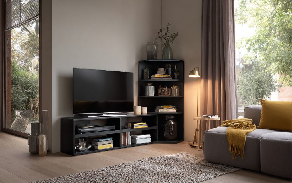 Compact black corner TV unit in small living space