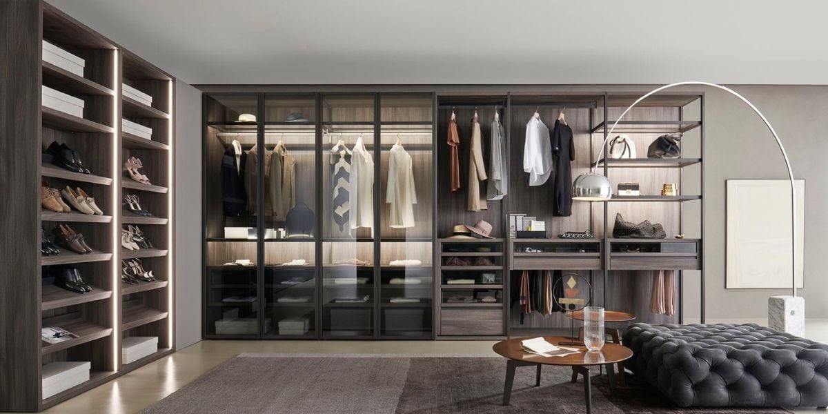 Floor-to-ceiling oak fitted wardrobe with full internal configuration in a luxury primary bedroom suite