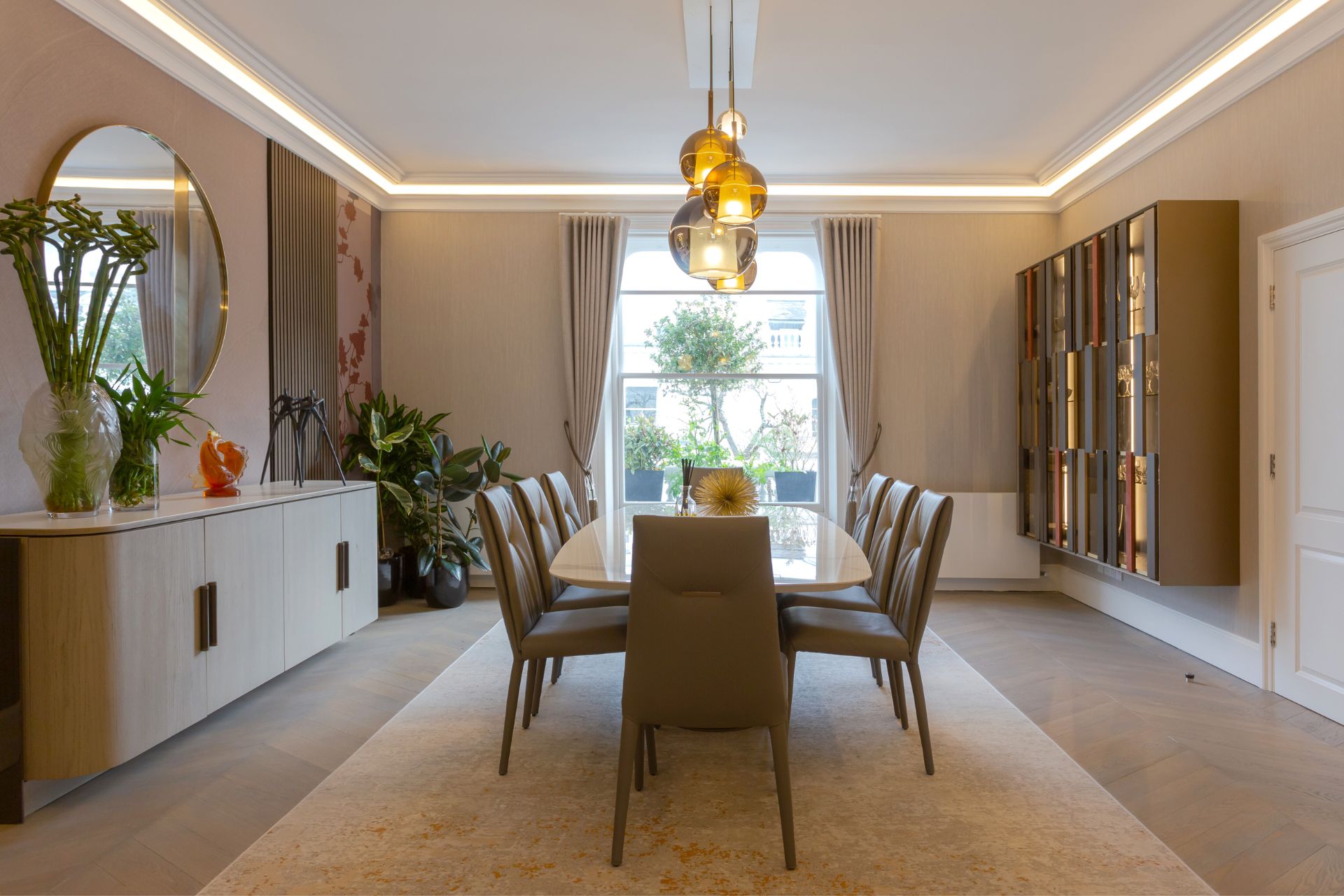 Sophisticated dining room with a large table, modern pendant lighting, and elegant decor.